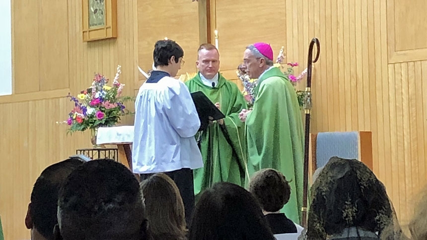 Father Patrick Keane is installed Aug. 4 at his new parish, Our Lady of Lourdes in Raleigh.