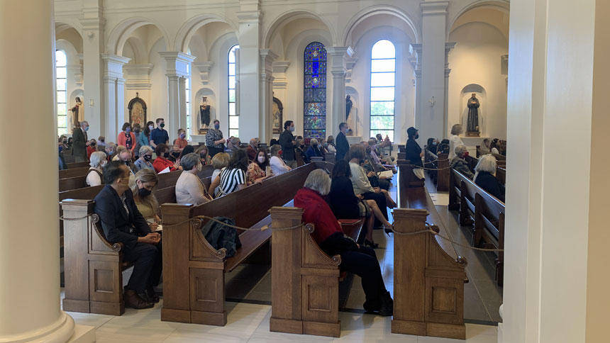 Representatives process toward the altar area to receive the holy oils.