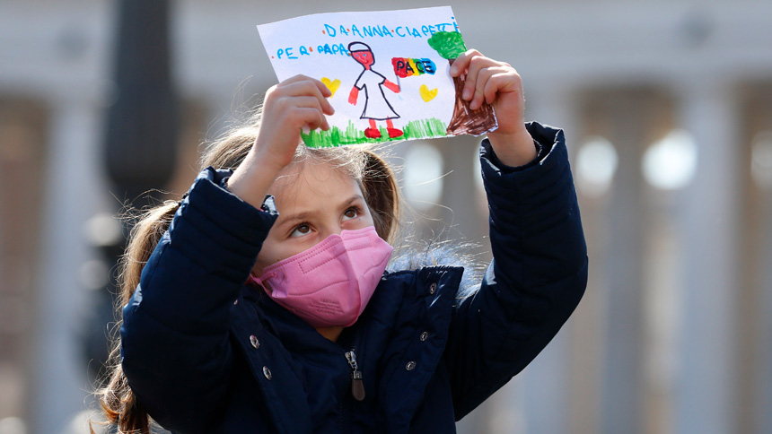 A girl holds artwork showing Pope Francis holding a peace flag as the pope leads the Angelus from the window of his studio overlooking St. Peter's Square at the Vatican March 13, 2022. Appealing again for peace in Ukraine, Pope Francis said those who support violence profane the name of God. (CNS photo/Paul Haring)