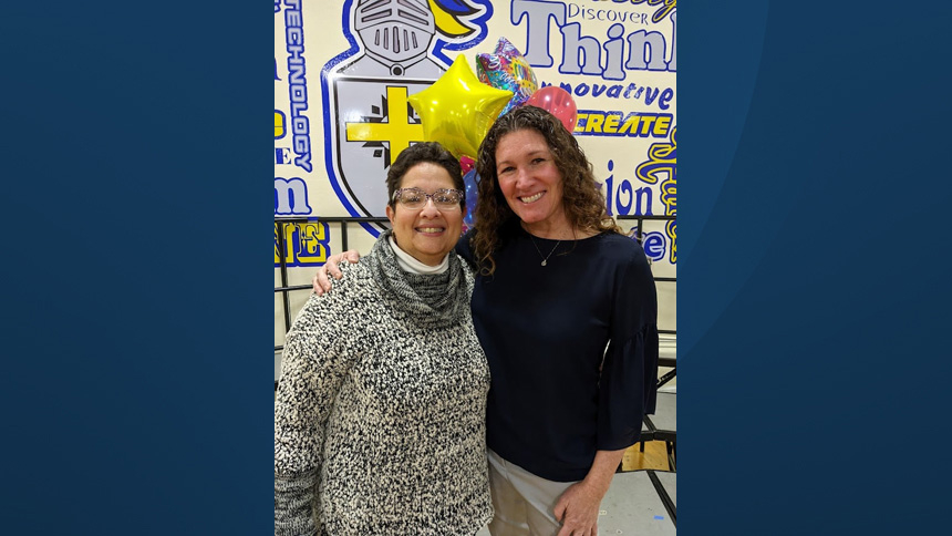 Principal Maria Iniquen-Gomez and teacher Kelly Champion learn Champion will receive a Lewis Award.