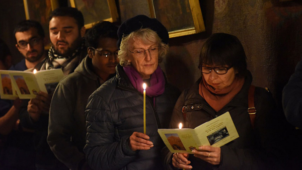 Pilgrims are seen in a file photo praying in the grotto of the Church of Nativity in Bethlehem, West Bank. (CNS photo/Debbie Hill)